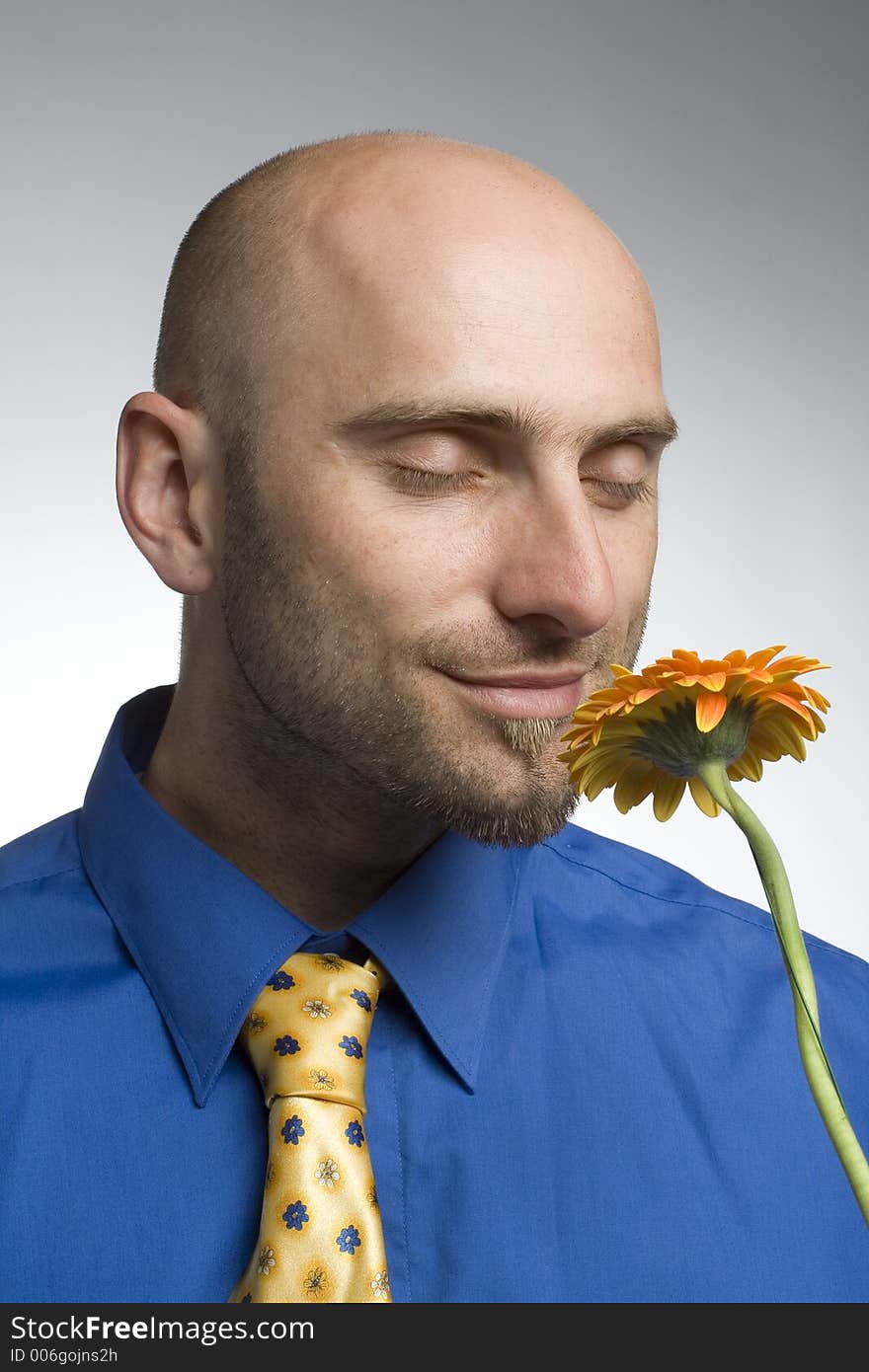 Young man smelling the flower(halfdetail). Young man smelling the flower(halfdetail)