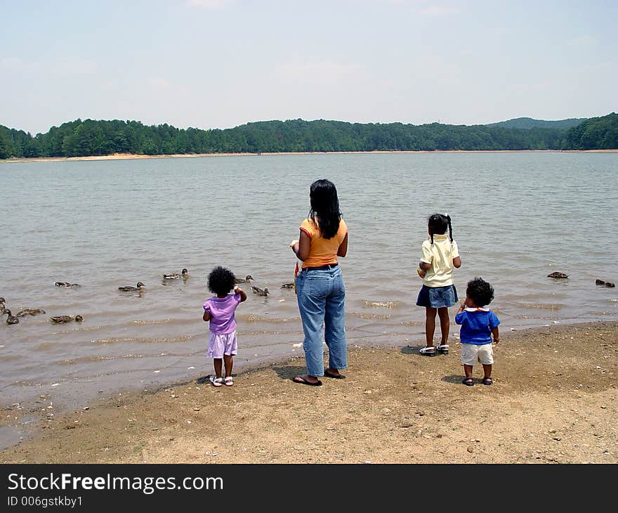 Mother and children feeding ducks at Sweetwater state park Georgia. Mother and children feeding ducks at Sweetwater state park Georgia