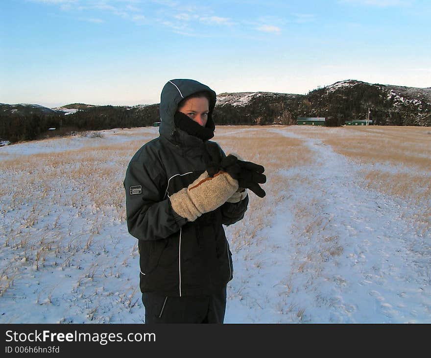 A girl stands in the freezing wilderness. A girl stands in the freezing wilderness