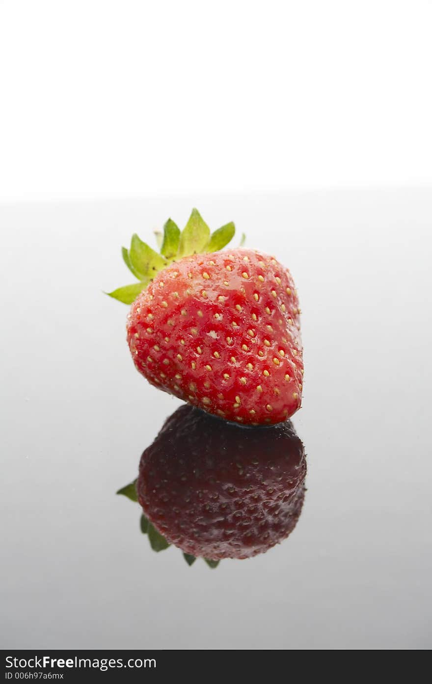 Wet strawberry on black background with reflection. Wet strawberry on black background with reflection