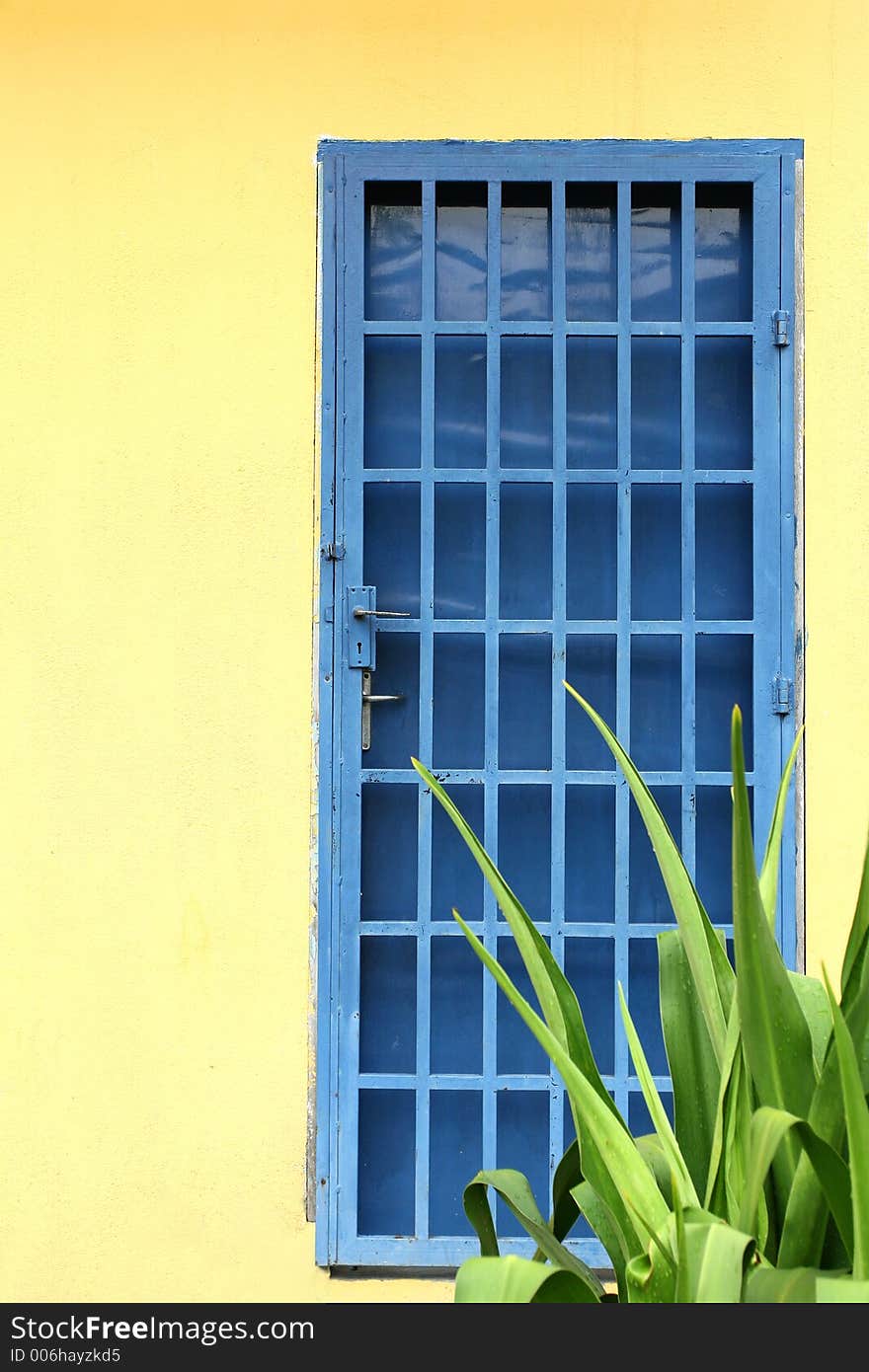 Yellow wall and blue door. Yellow wall and blue door