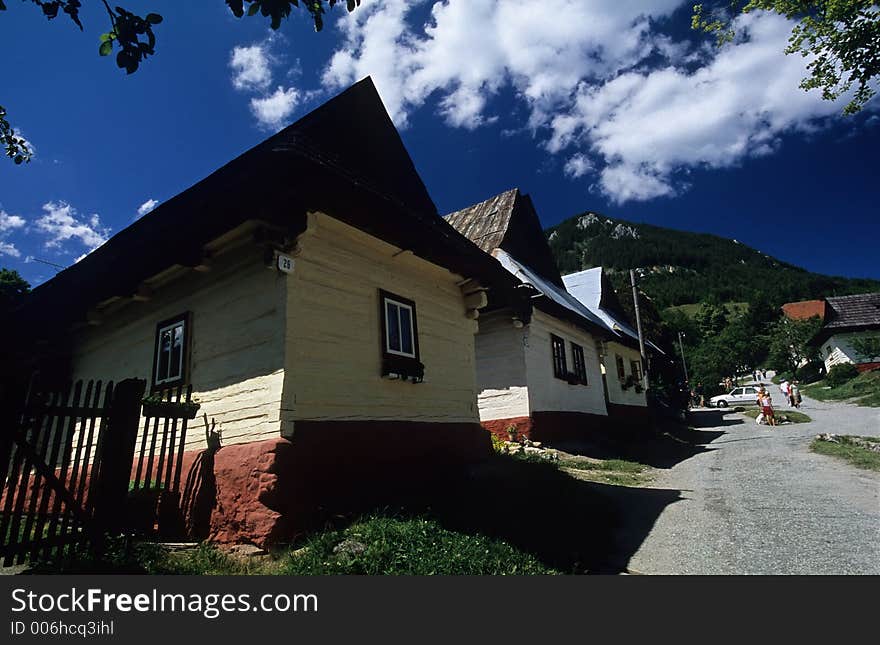 Wooden houses crouch beside one another and radiate from one main road that is sliced by a stream carrying one of the village's primary sources of water. Wooden houses crouch beside one another and radiate from one main road that is sliced by a stream carrying one of the village's primary sources of water.