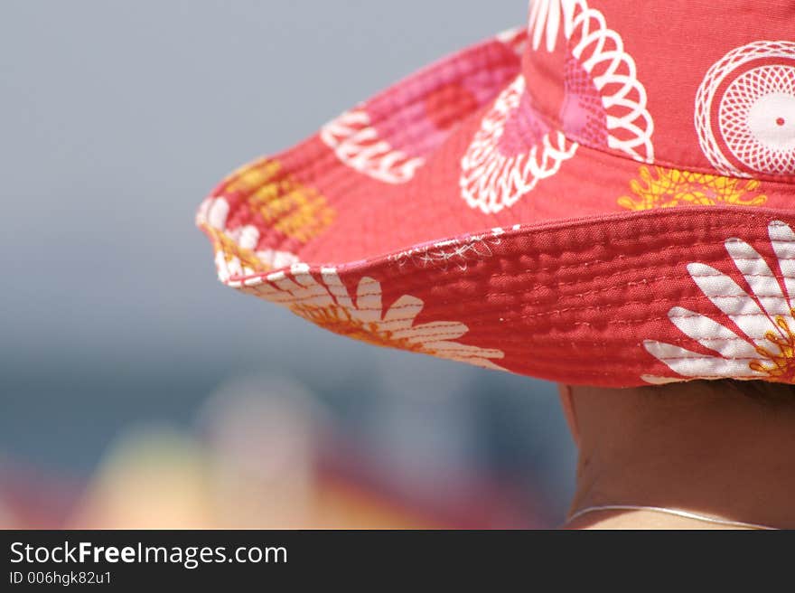 Back of head and hat, on the beach