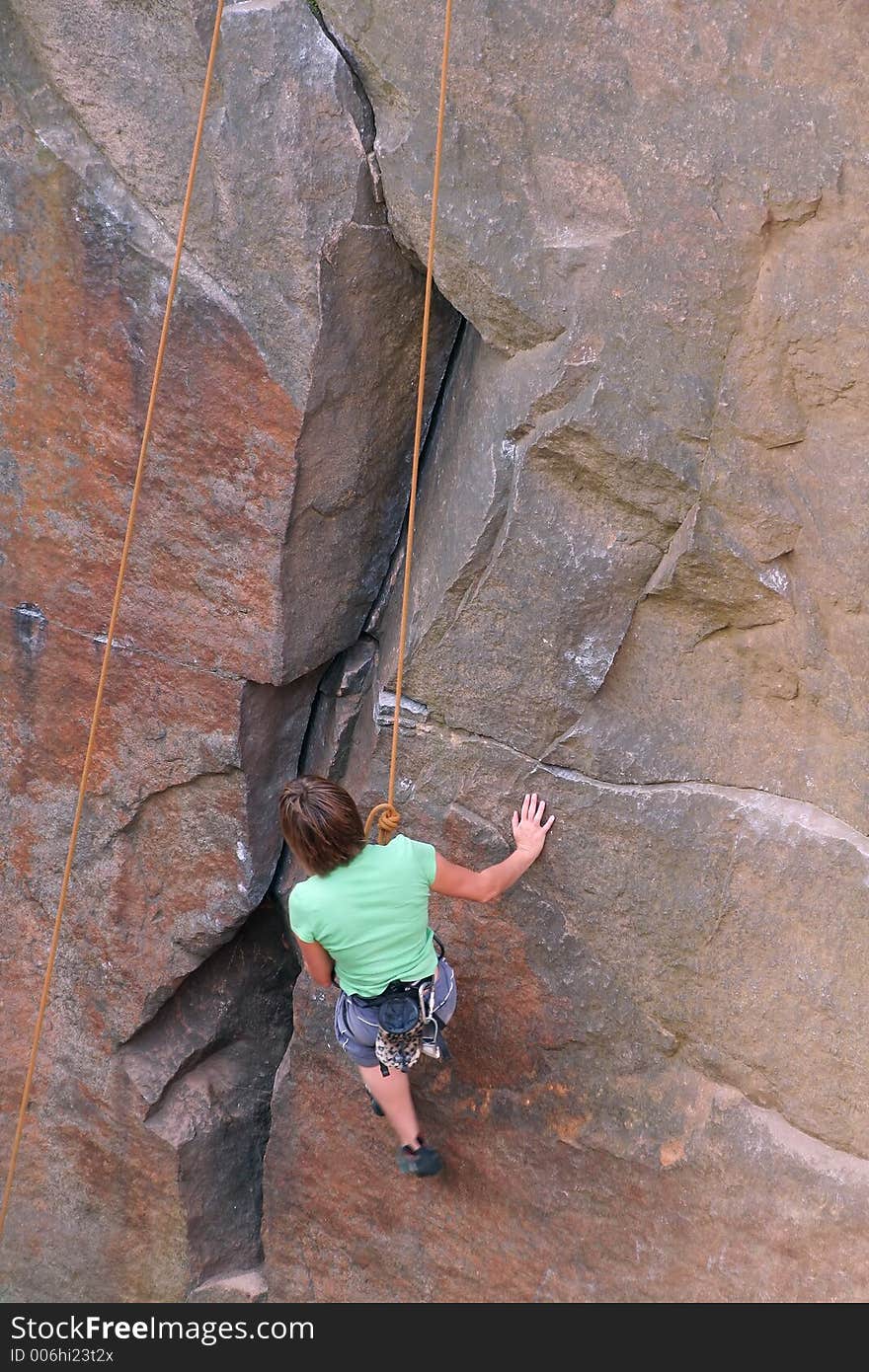 Woman rock climber on cliff face