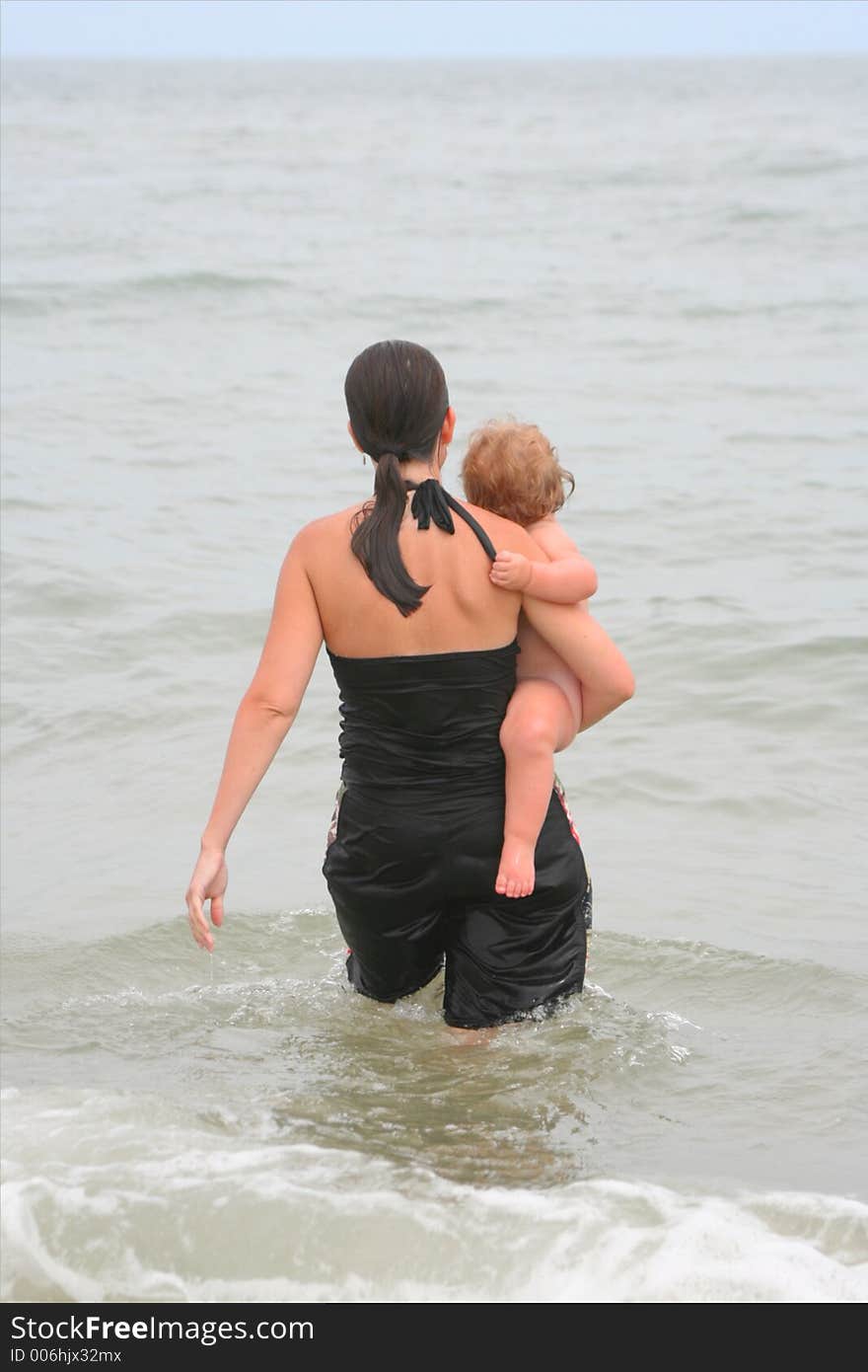 Mother and child take a dip in the Ocean. Mother and child take a dip in the Ocean