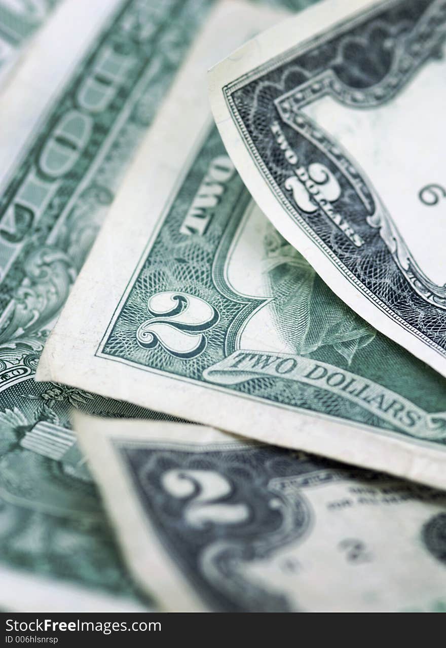 Pile of two dollar bills (and a one dollar bill) - vertical format - narrow depth of field. Pile of two dollar bills (and a one dollar bill) - vertical format - narrow depth of field