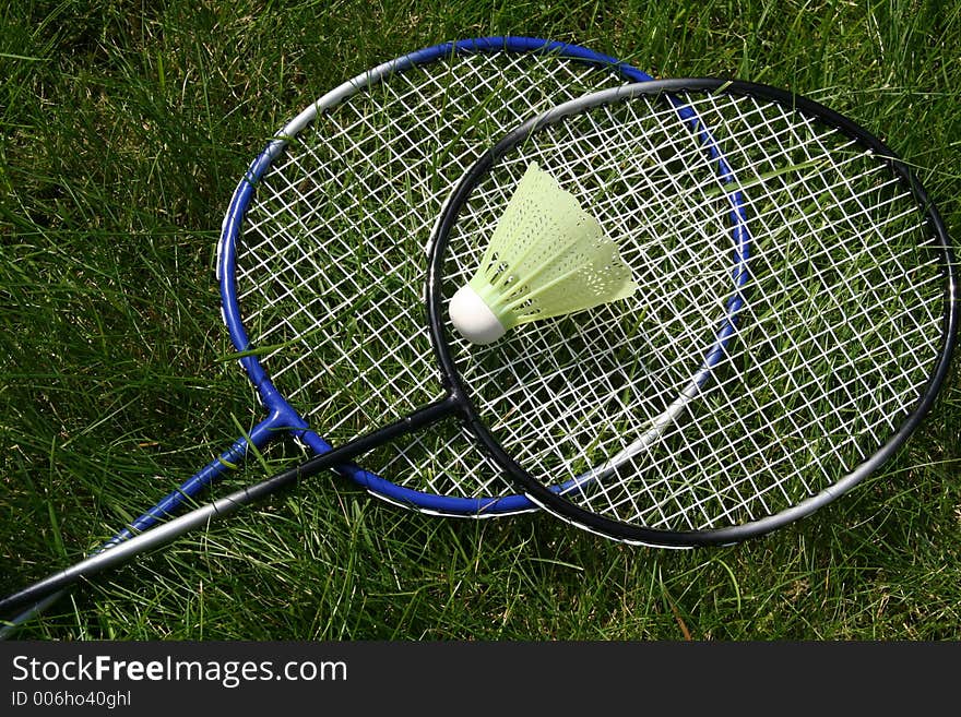 Badminghton rackets laying in the grass. Badminghton rackets laying in the grass