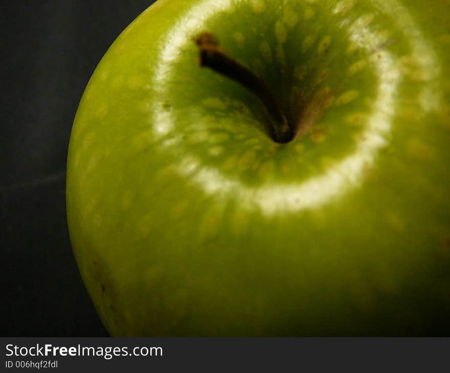 Big Granny Smith apple on a black background.