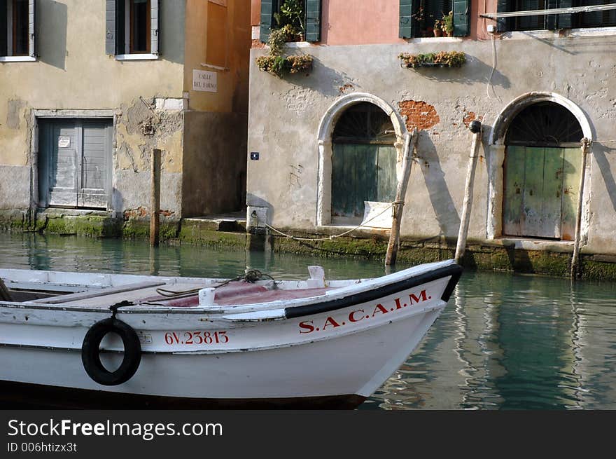 Boat in canal in Venice, Italy. Boat in canal in Venice, Italy.