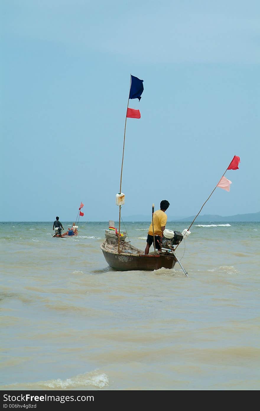 Two wooden, longtail fishing-boats leaving the coast of Na Jomtien, Chonburi province, Thailand. Two wooden, longtail fishing-boats leaving the coast of Na Jomtien, Chonburi province, Thailand