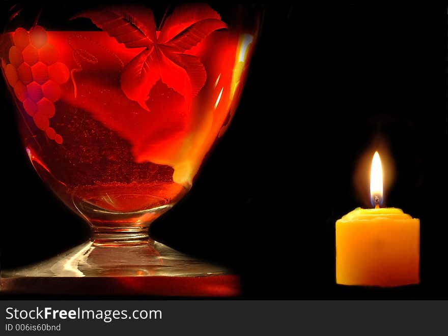 Carafe and candle on black background. Carafe and candle on black background