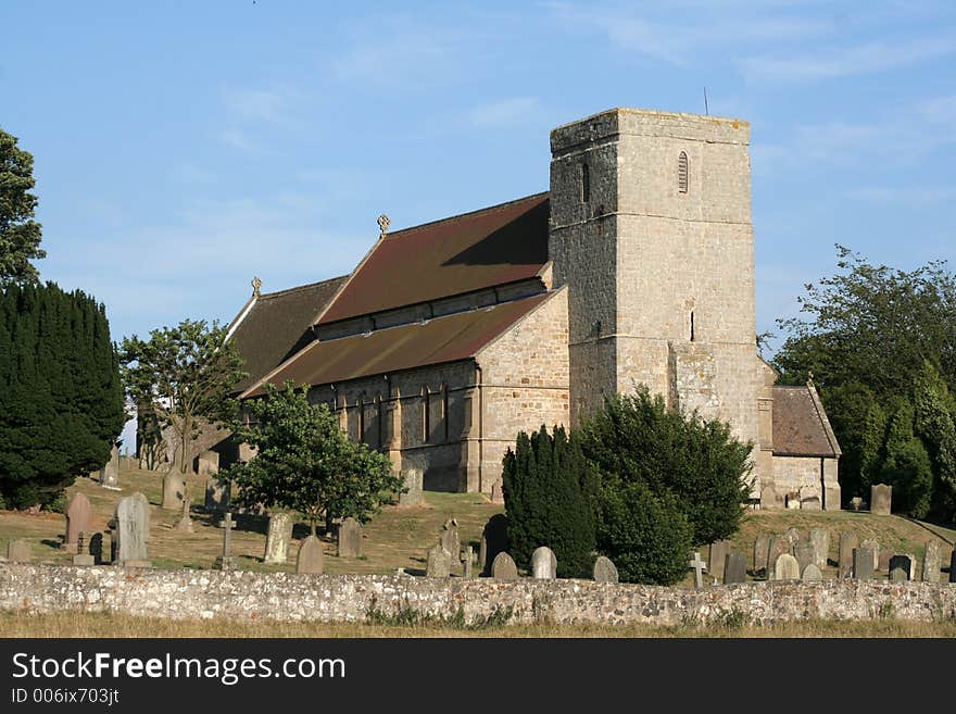 Beautiful church stands on a hill with a graveyard around it. Beautiful church stands on a hill with a graveyard around it