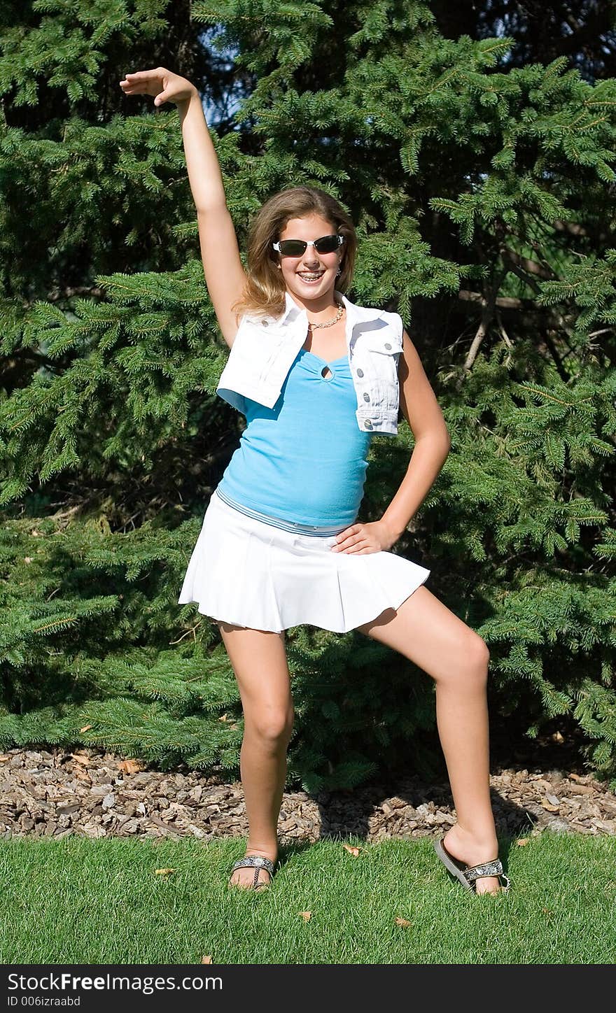 Pretty Teenage Girl In Sunglasses Striking A Pose