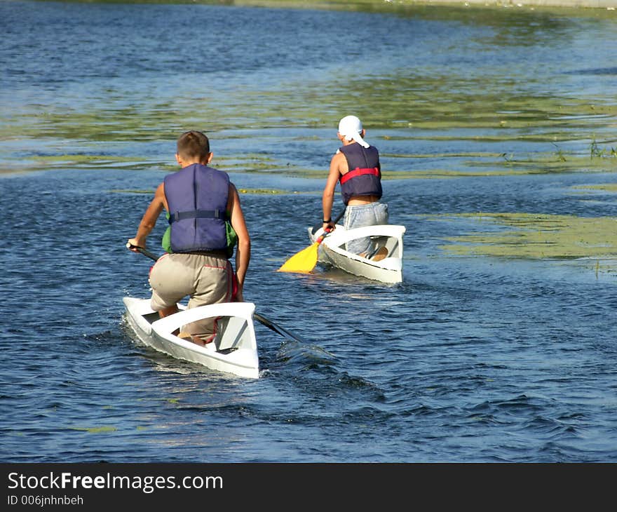 Two young boy in kayaks. Two young boy in kayaks