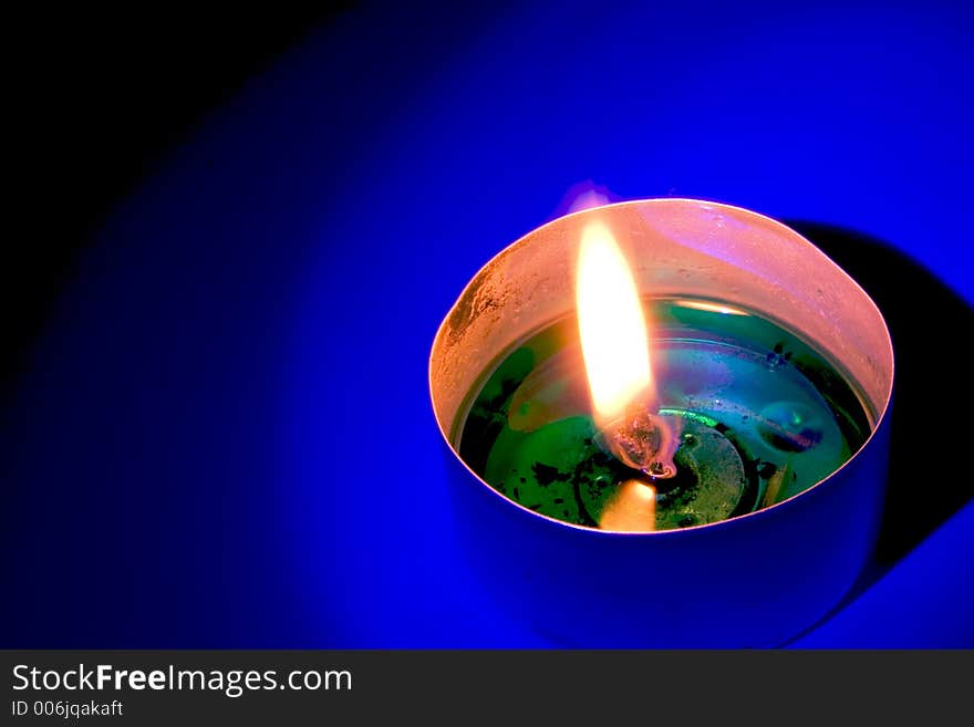 Candle in blue light. Candle in blue light