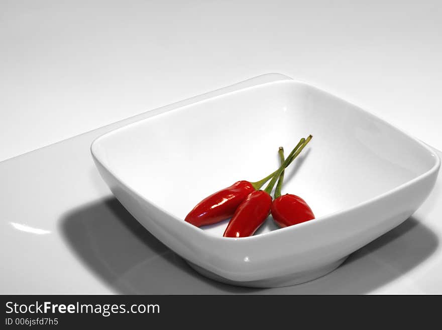 Chili on white porcelain. Chili on white porcelain