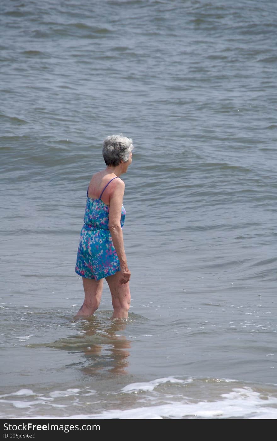 Mature woman enjoying the summer surf. Mature woman enjoying the summer surf