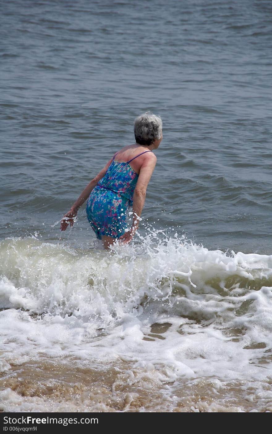 Mature woman enjoying the summer surf. Mature woman enjoying the summer surf