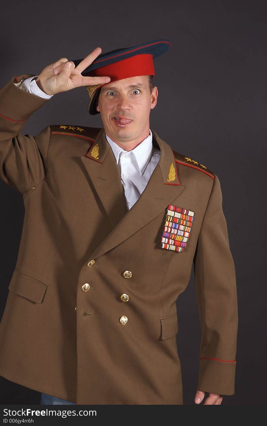 Portrait of a man dressed in a military uniform, with a humorous expression on his face. Portrait of a man dressed in a military uniform, with a humorous expression on his face