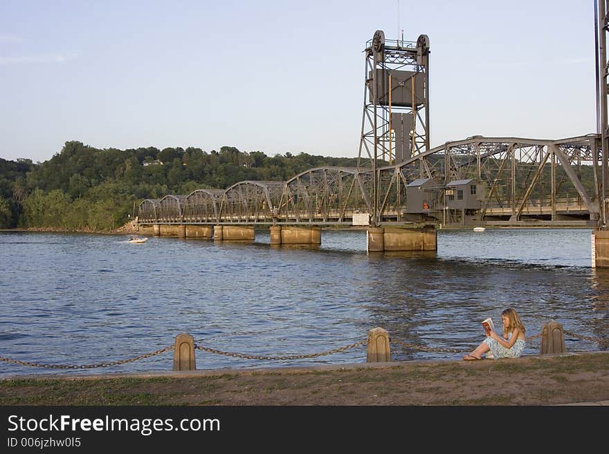 Ryley is reading by the stillwater bridge in MN. Ryley is reading by the stillwater bridge in MN