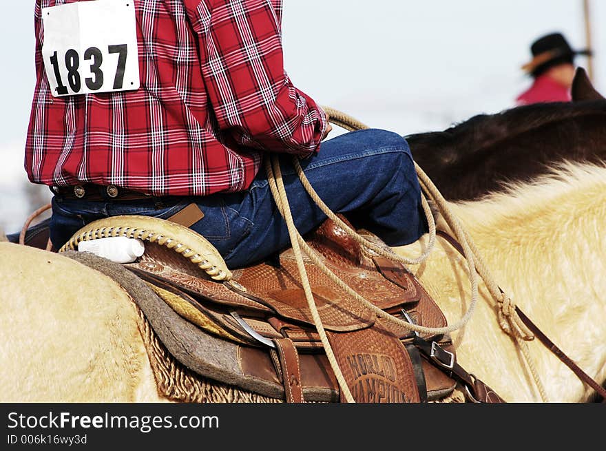 A cowboy waits to compete in the roping competition. A cowboy waits to compete in the roping competition.