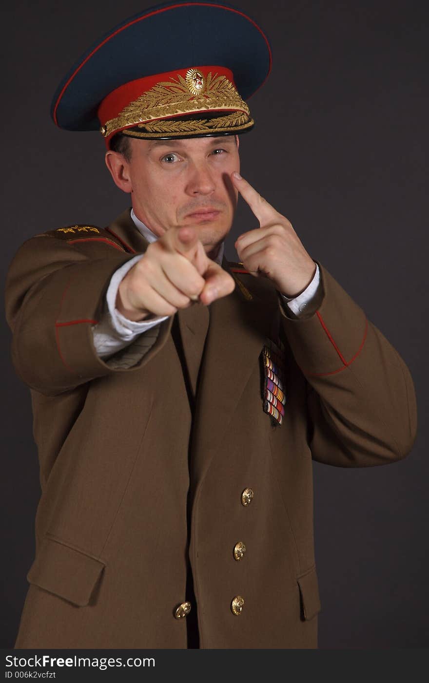 A man in a military uniform, with his arm extending pointing directly at the camera. A man in a military uniform, with his arm extending pointing directly at the camera