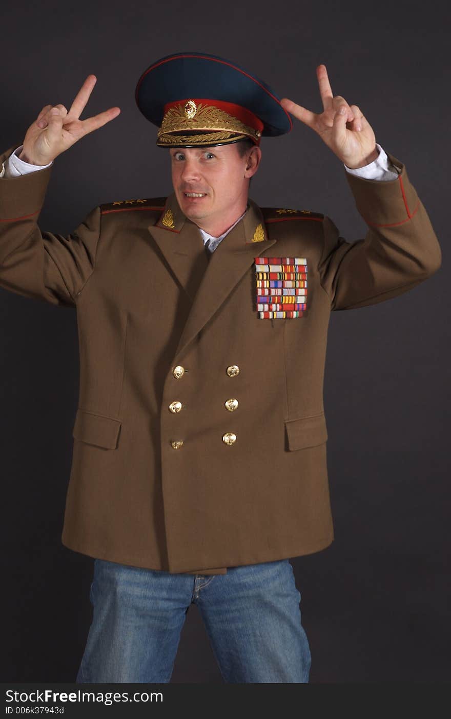 Portrait of a man dressed in a military uniform, with a humorous expression on his face. Portrait of a man dressed in a military uniform, with a humorous expression on his face