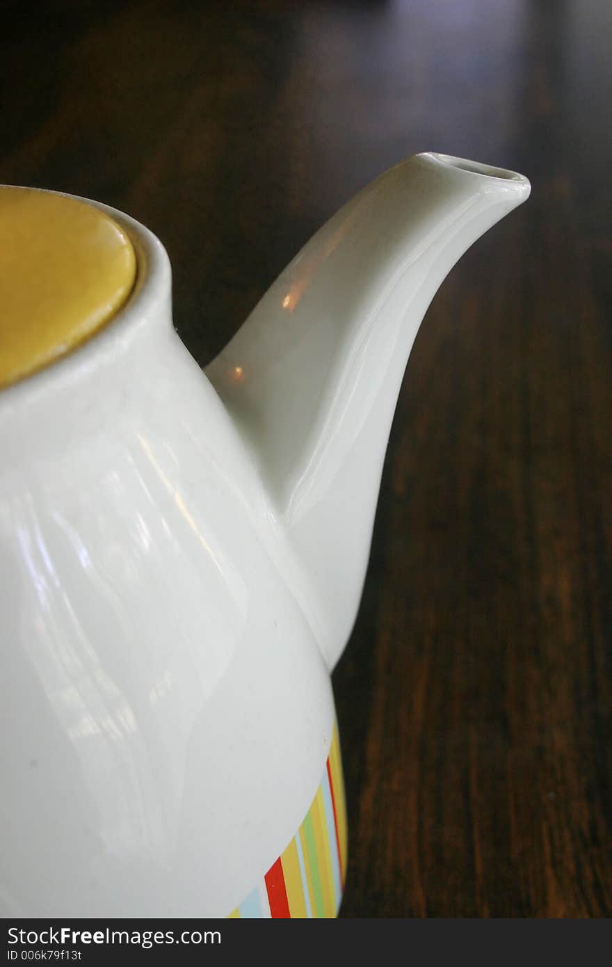 A teapot on a table. A teapot on a table