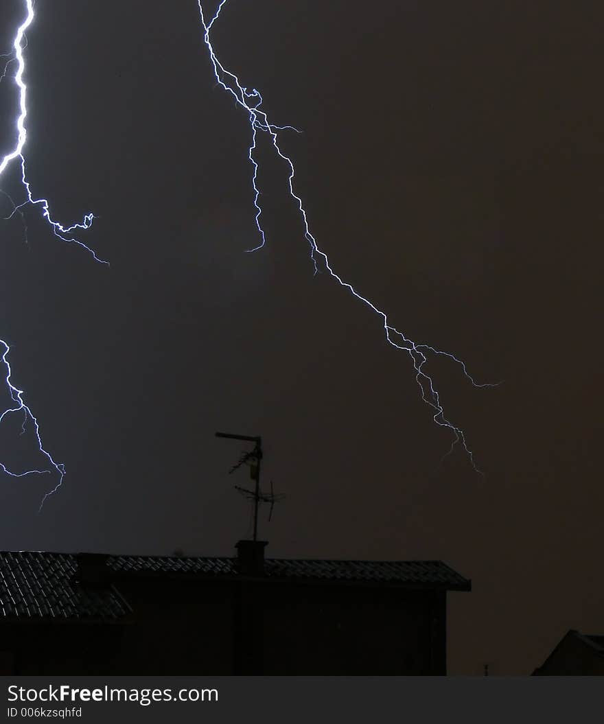 Lightning over rooftops. Lightning over rooftops