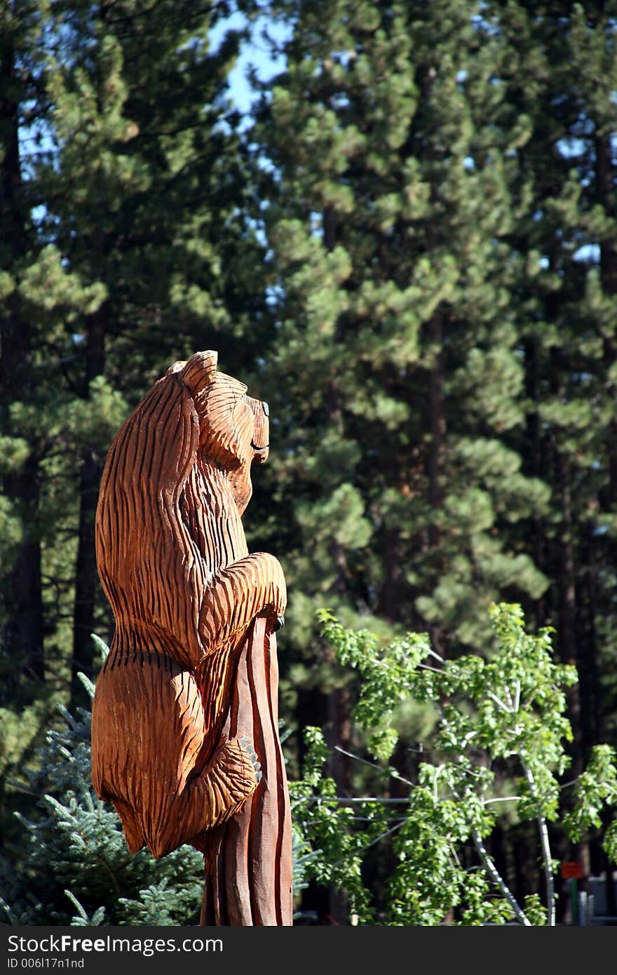 Wooden bear looking off into the wilderness