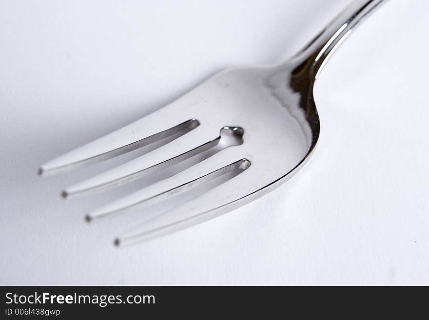 A single fork on a white background. A single fork on a white background