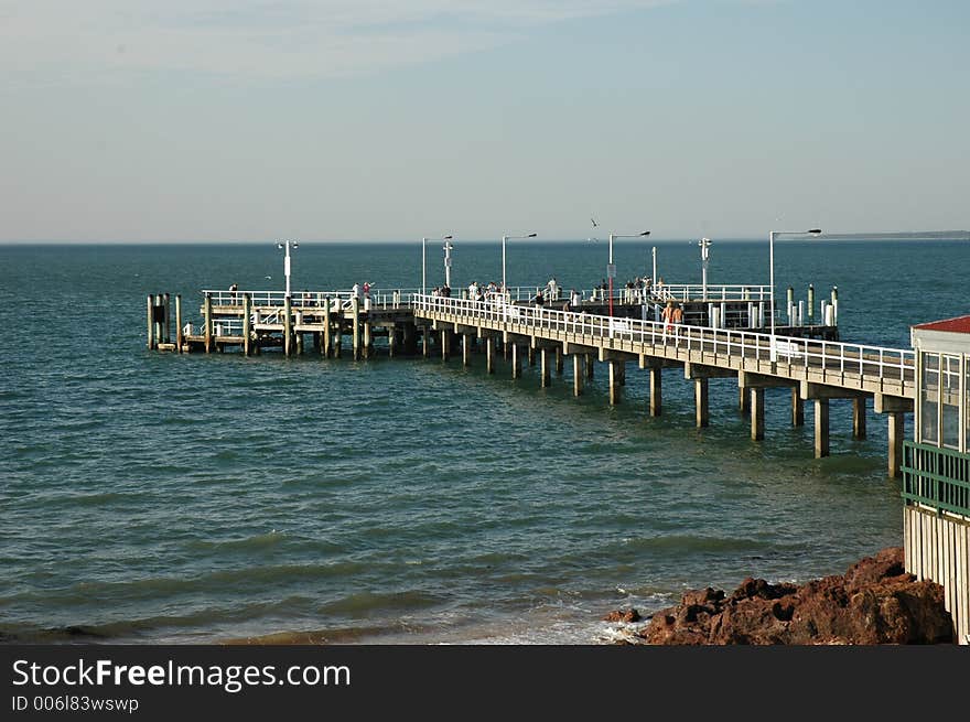 Shot of an island pier crowded with tourists. Shot of an island pier crowded with tourists.