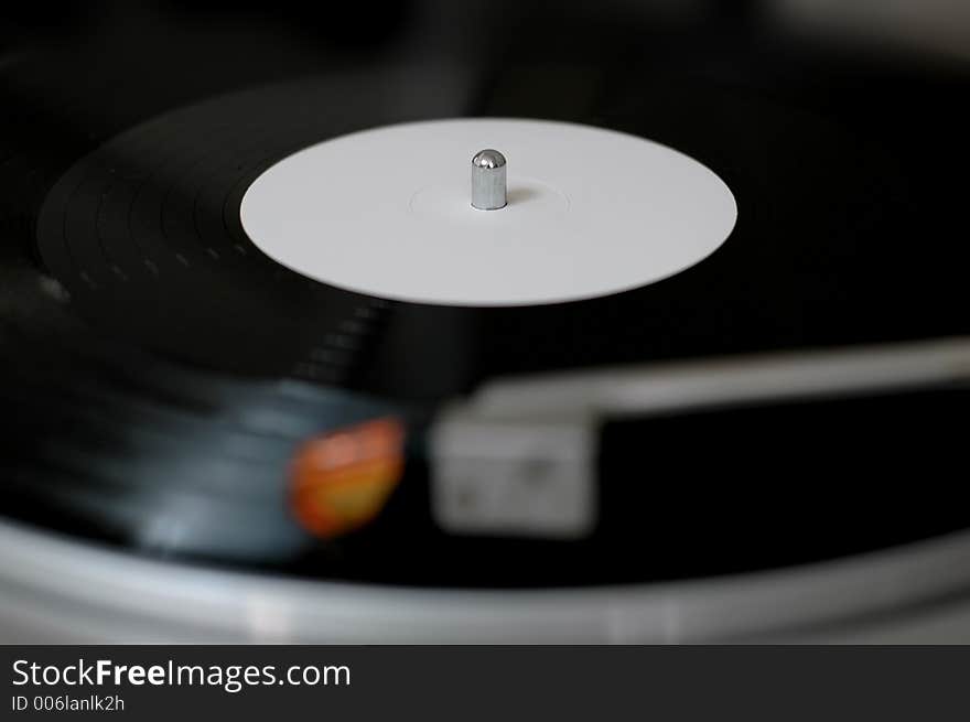 Playing a vinyl record on a turntable. Playing a vinyl record on a turntable.