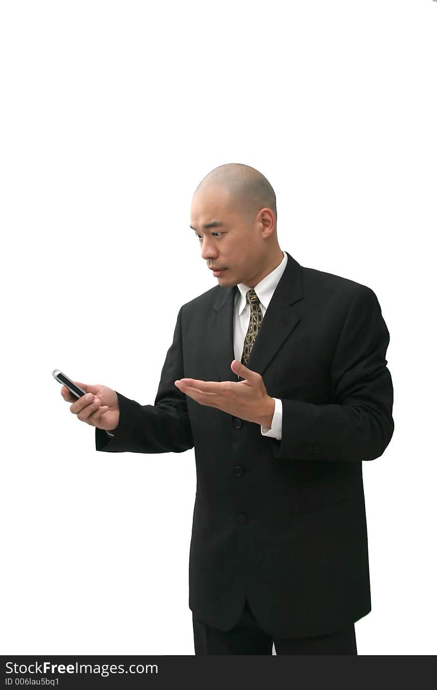 Oriental man in suit on cell phone looking puzzled, angry  or annoyed. Oriental man in suit on cell phone looking puzzled, angry  or annoyed.