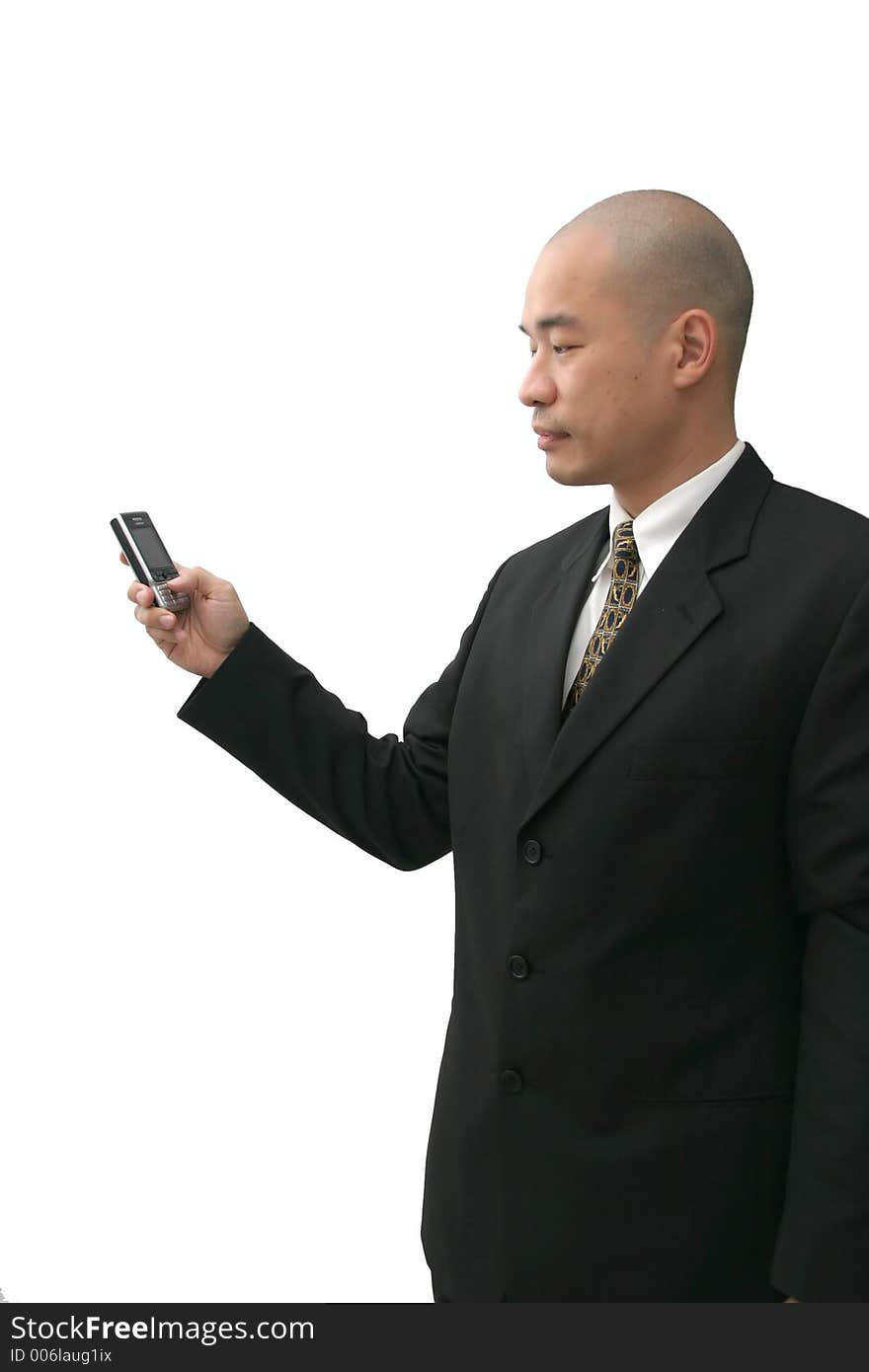 Oriental man in suit on cell phone looking indifferent. Oriental man in suit on cell phone looking indifferent