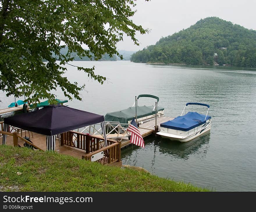 Boats docked ready to be used in the mountain lake. Boats docked ready to be used in the mountain lake