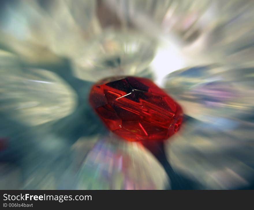 A red bead accented against other clear beads. A red bead accented against other clear beads.