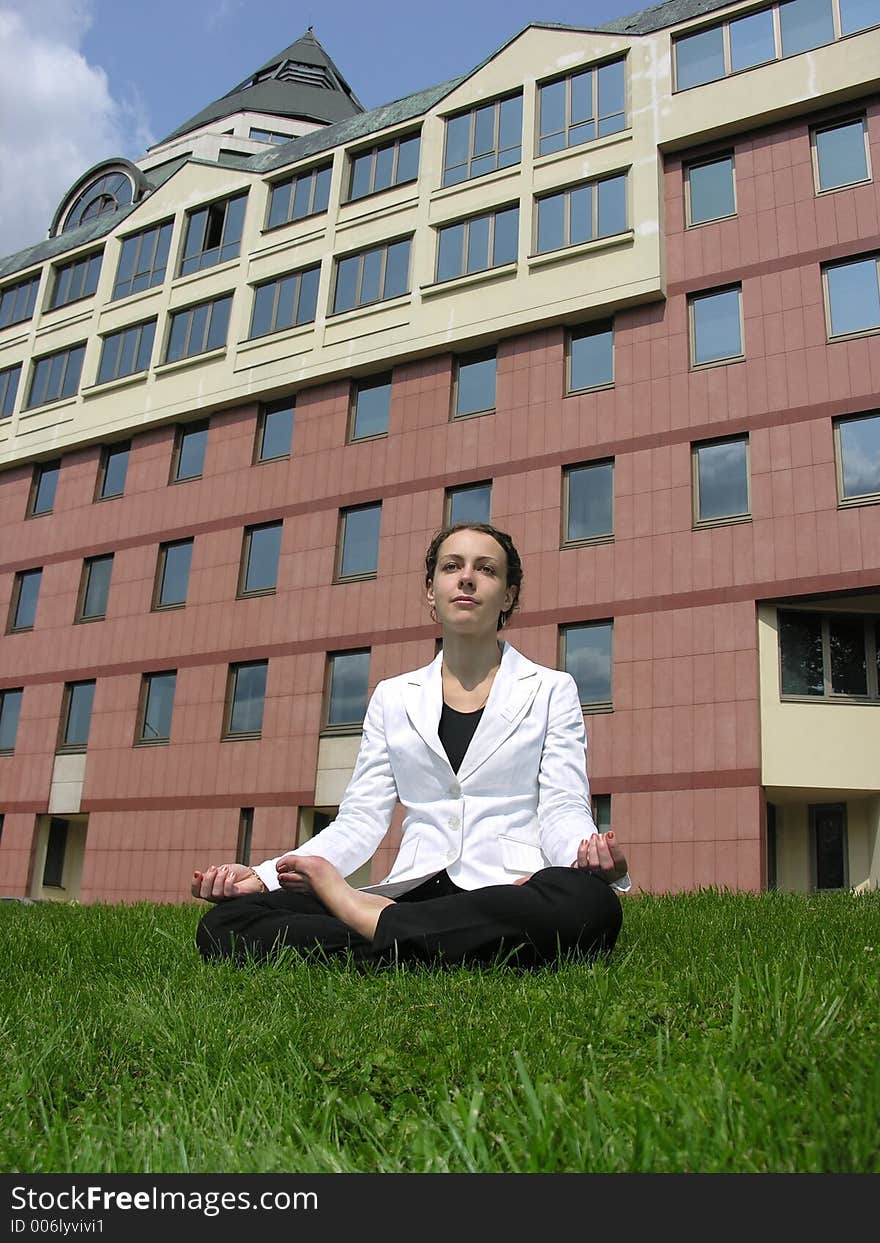 Yoga businesswoman on grass