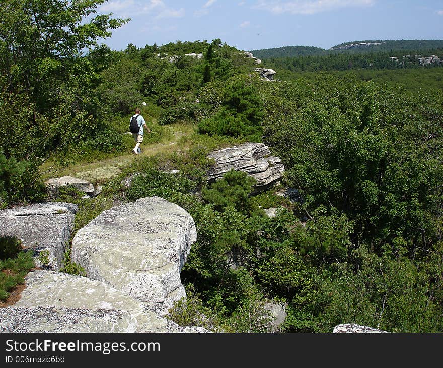 Man hiking via cliff edge