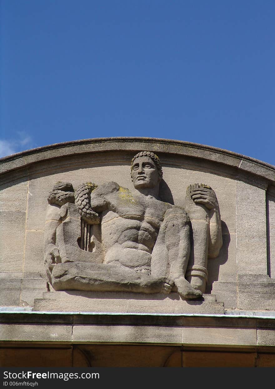 Art deco sculpture of man on palace building