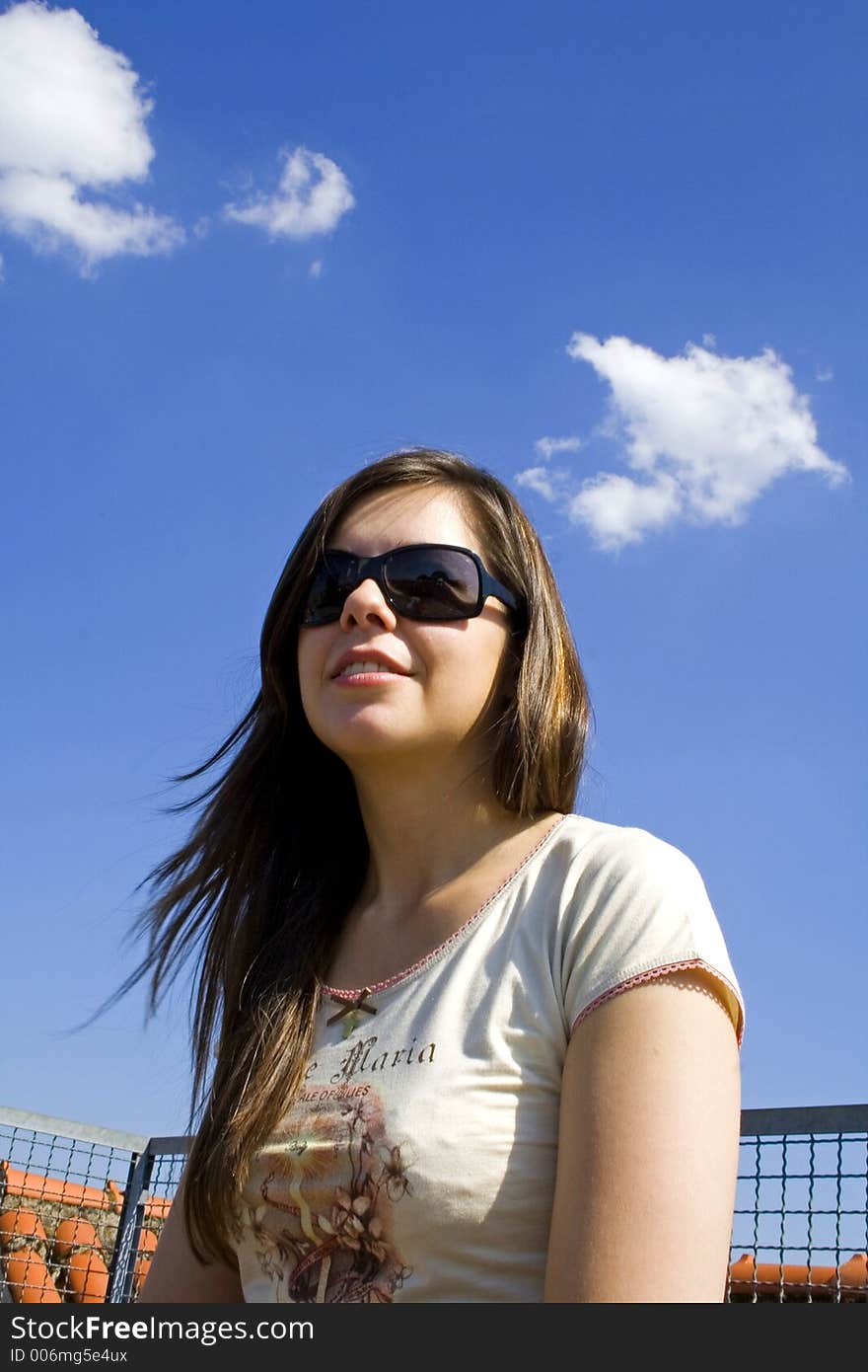 Sitting brunette on blue sky. Sitting brunette on blue sky