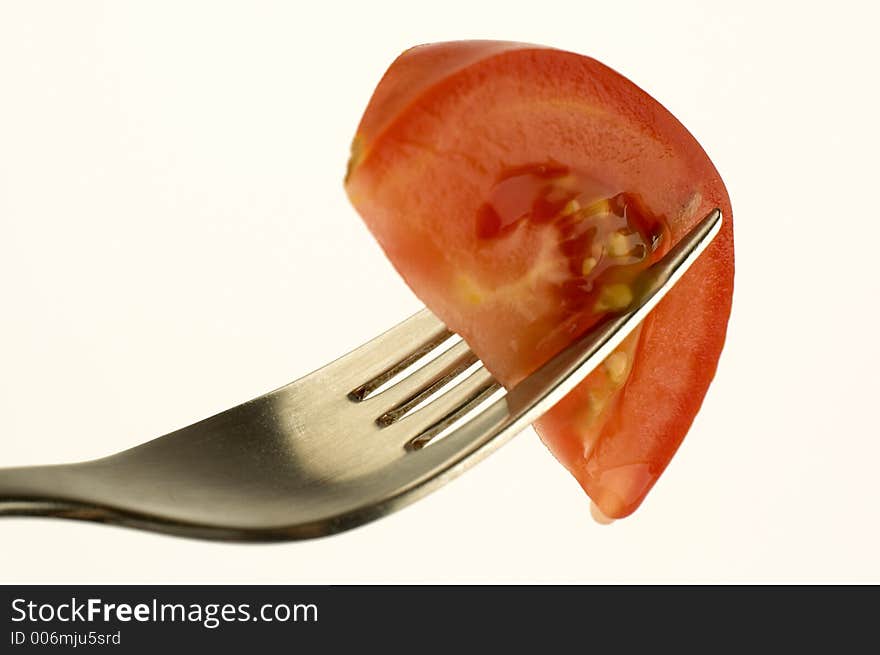 Tomato piece on a fork. Tomato piece on a fork