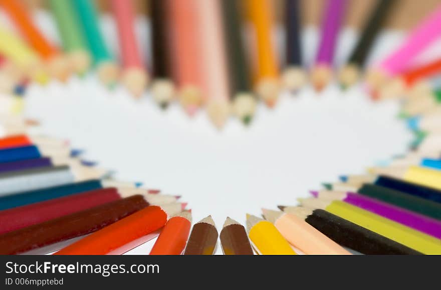 Colored pencils in a heart shape. Colored pencils in a heart shape