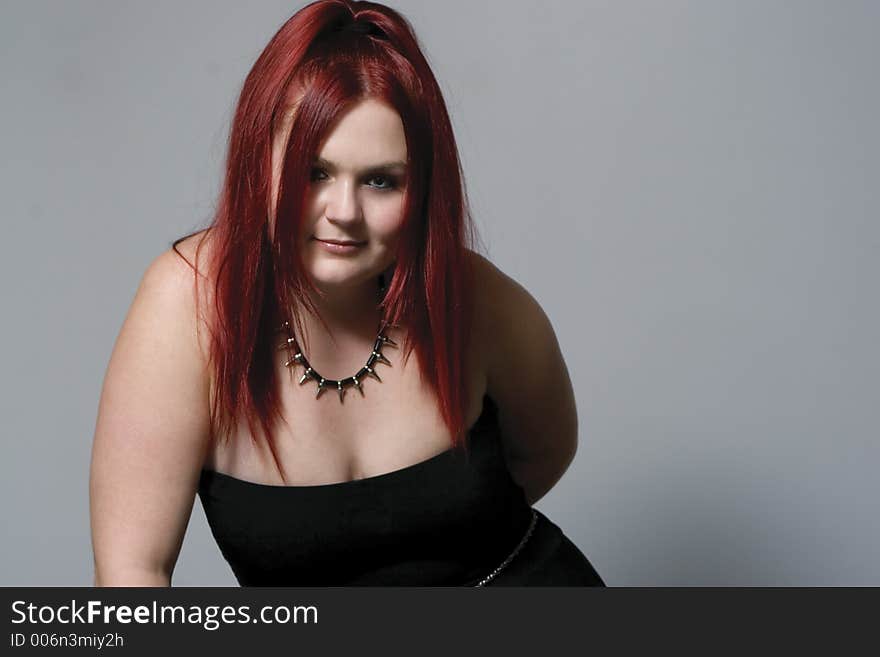 Red hair female model in suggestive position and goth look. Red hair female model in suggestive position and goth look