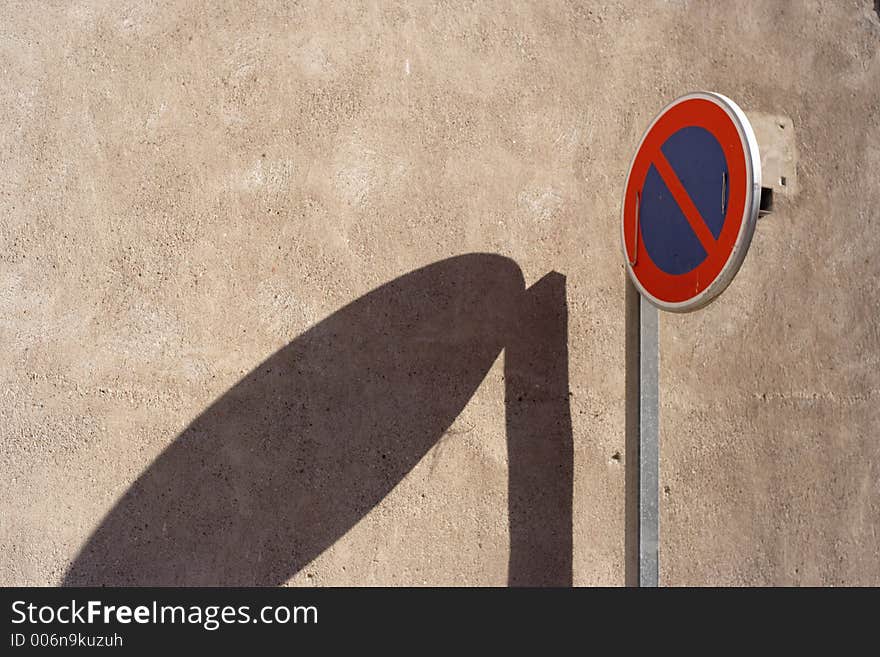 No entry sign and long shadow cast by afternoon light. No entry sign and long shadow cast by afternoon light