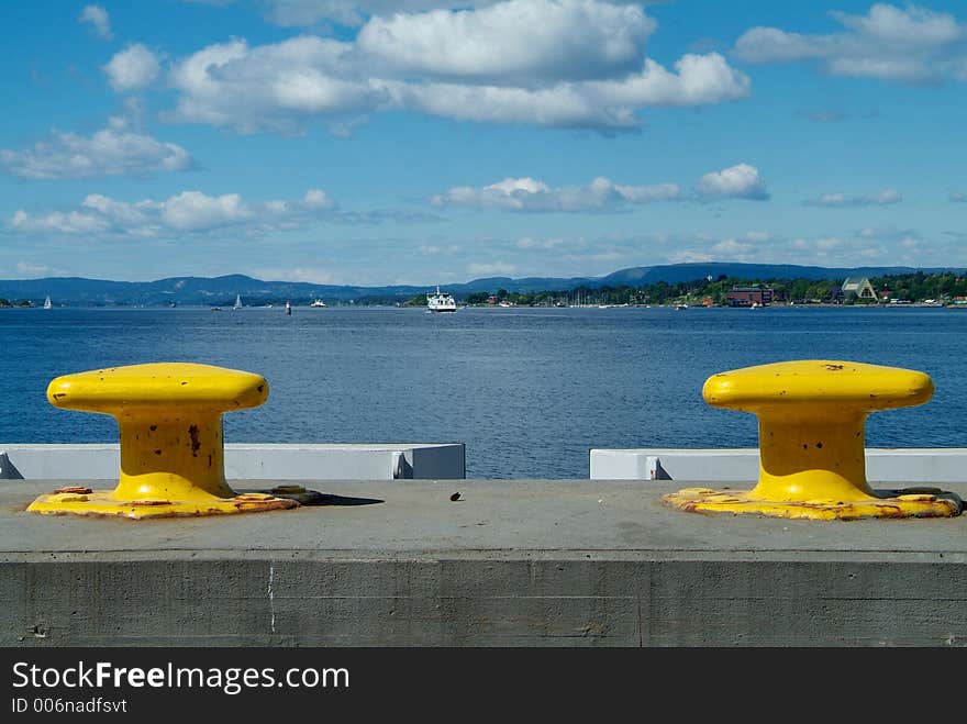 Two yellow cleats with a view over the Oslofjord, Norway