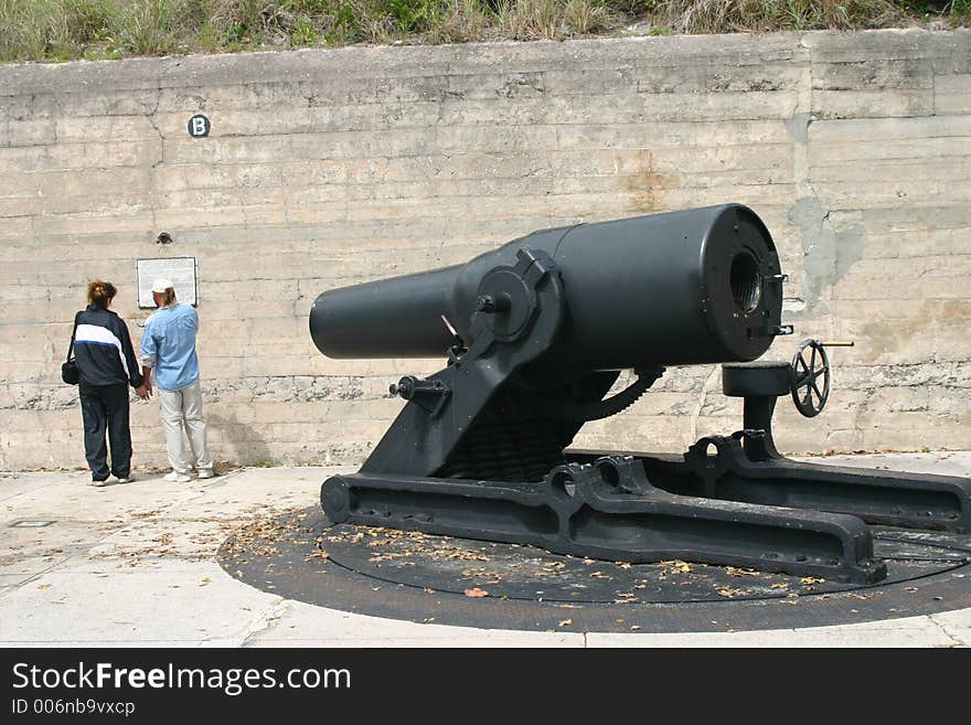 Large black cannon and couple at historic Fort Desoto, Florida. Large black cannon and couple at historic Fort Desoto, Florida