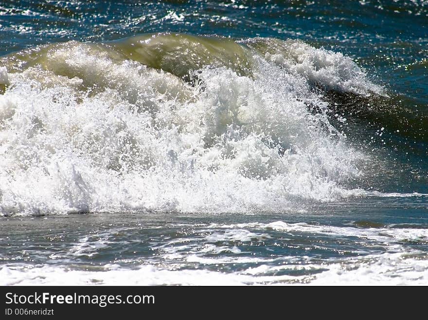 Waves on the beach, aside the sun