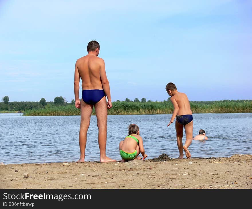 Family playing on the beach