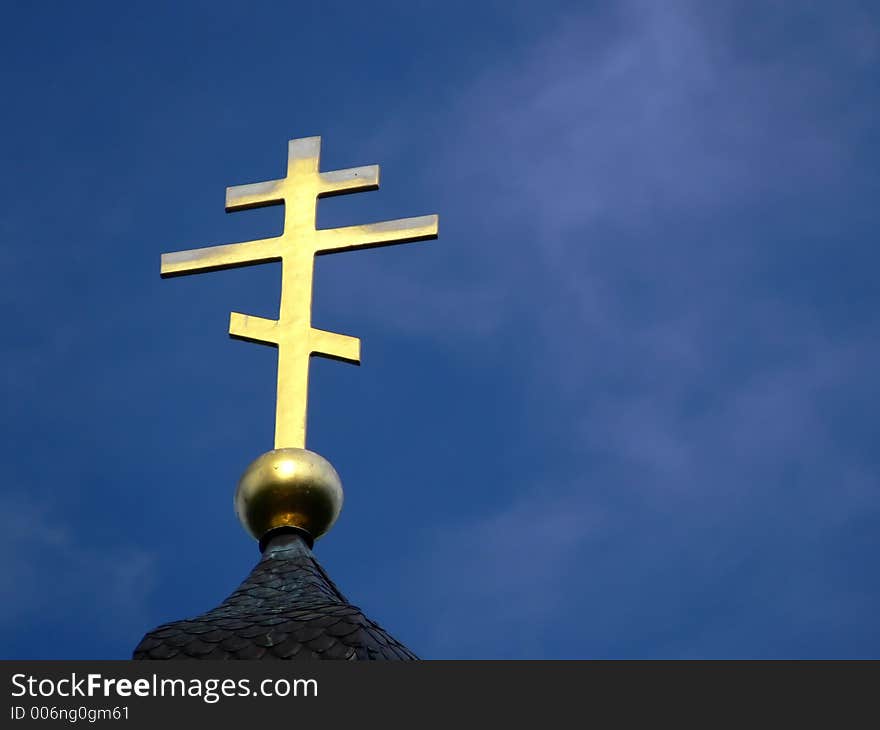 Golden Orthodox Cross On Blue Sky